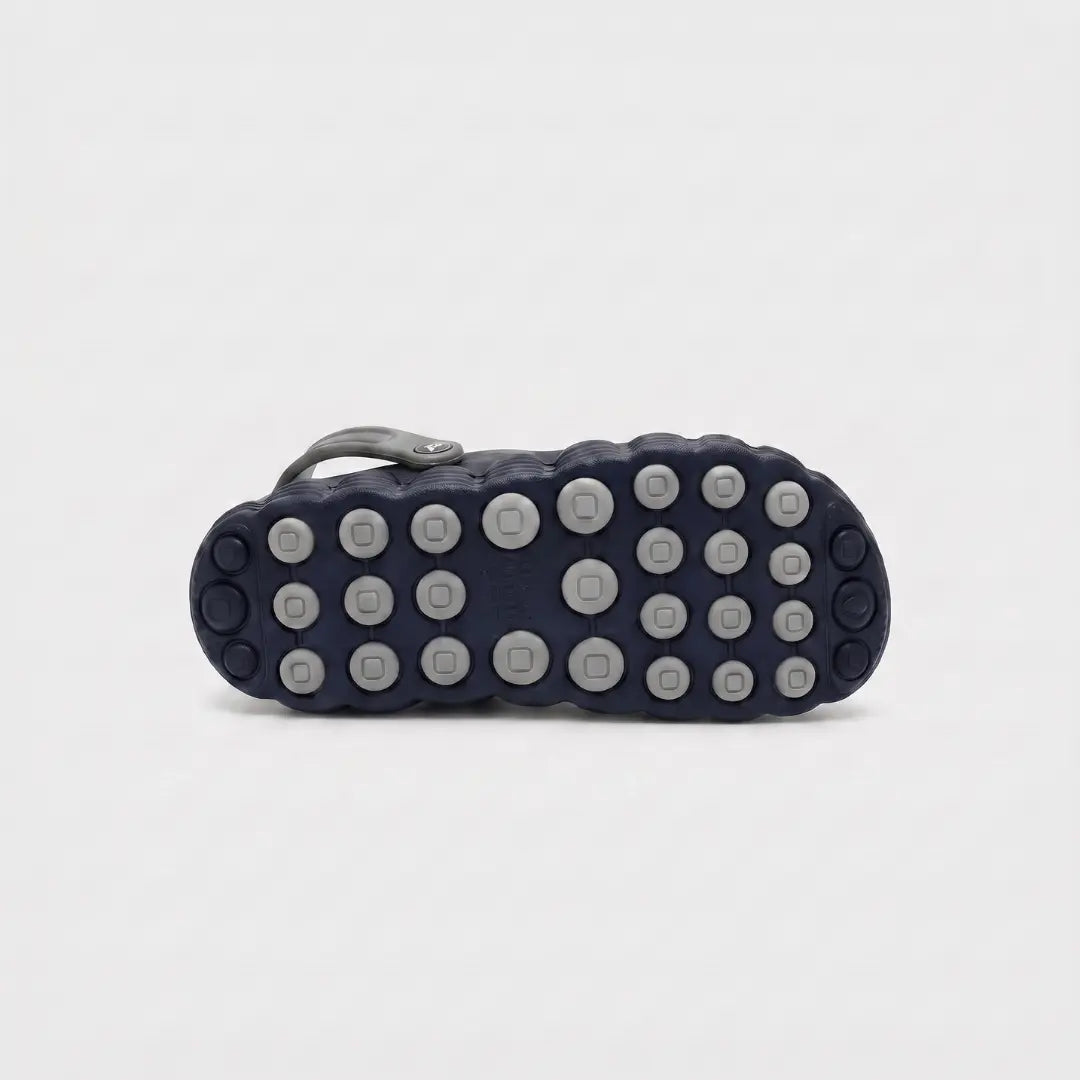 JunctionSole navy blue clog outsole close-up showing multi-direction grip tread