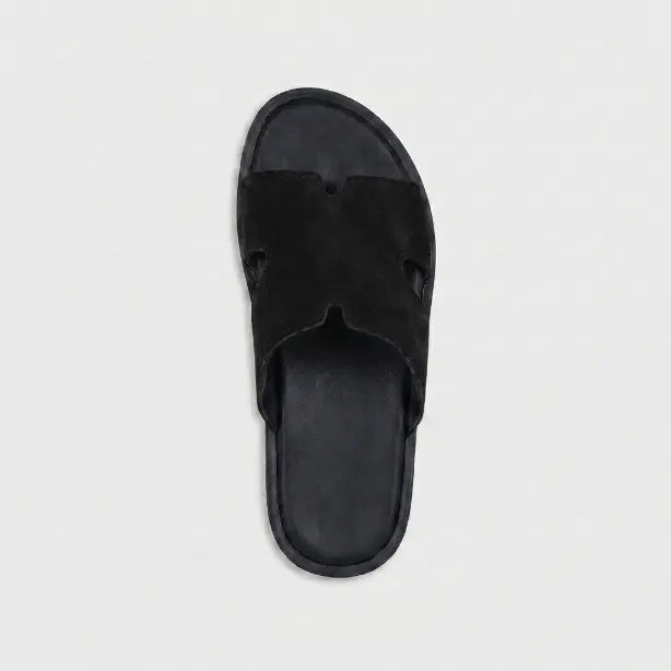 Junction Sole men's black suede comfort slides viewed from above, featuring soft cushioned footbed and cutout H-strap design for Pakistan.