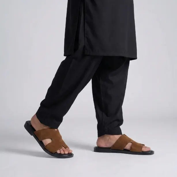 Man walking in Junction Sole brown suede comfort slides, showing lightweight cushioned sole ideal for daily wear across Pakistan.