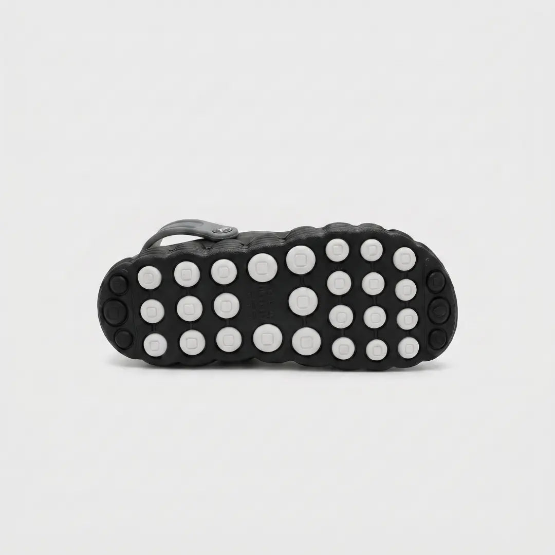 JunctionSole black clog outsole close-up showing durable traction grip pattern